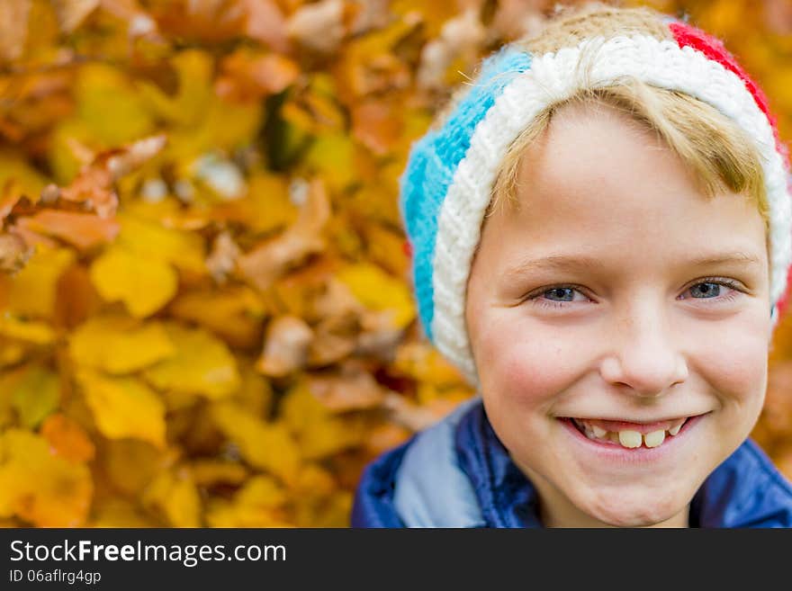 Portrait of a boy with colorful autumn leaves in the background. Portrait of a boy with colorful autumn leaves in the background