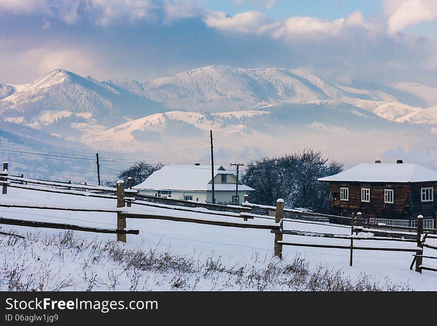 Snow-covered Mountains Behind Two Cotteges