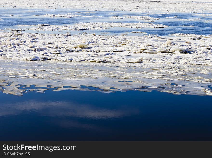 Ice drift on the river the late fall in the bright sunny day