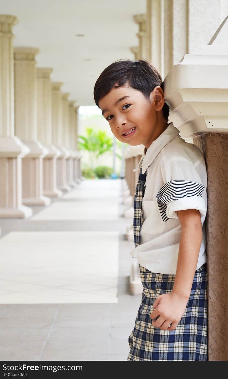 Student stand on sidwalk at school smiling