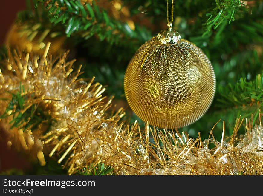 Christmas decoration on the tree with gold chain