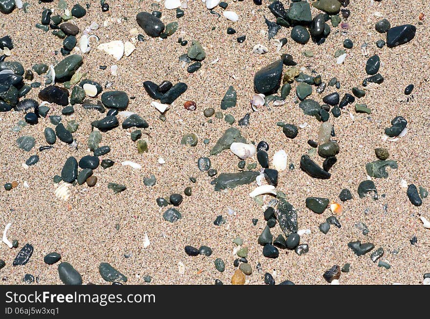 Stones on sand. Summer beach background. Top view