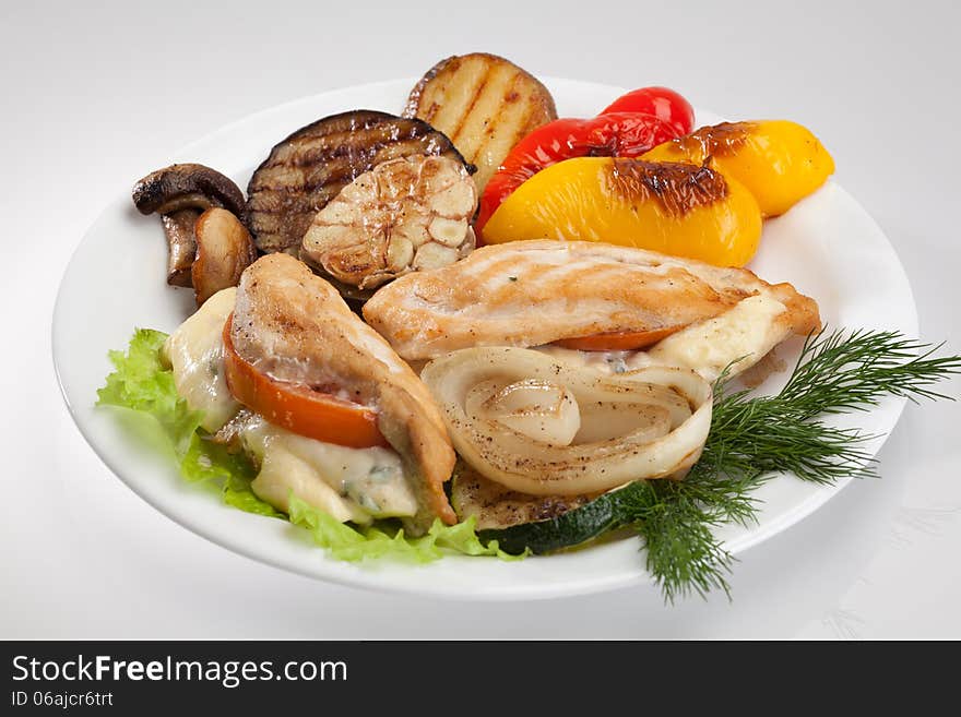 Grilled chicken on a plate isolated on white background