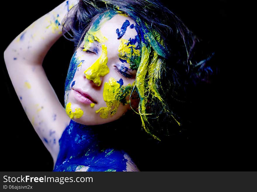 Beauty/fashion Portrait Of Woman Painted Blue And Yellow On Black Background