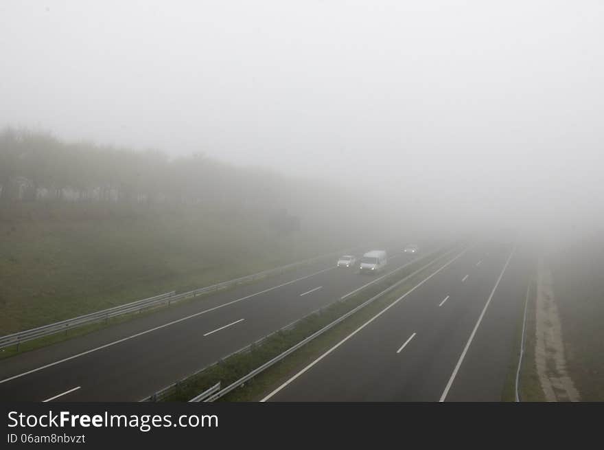 Foggy highway with three cars. Foggy highway with three cars.