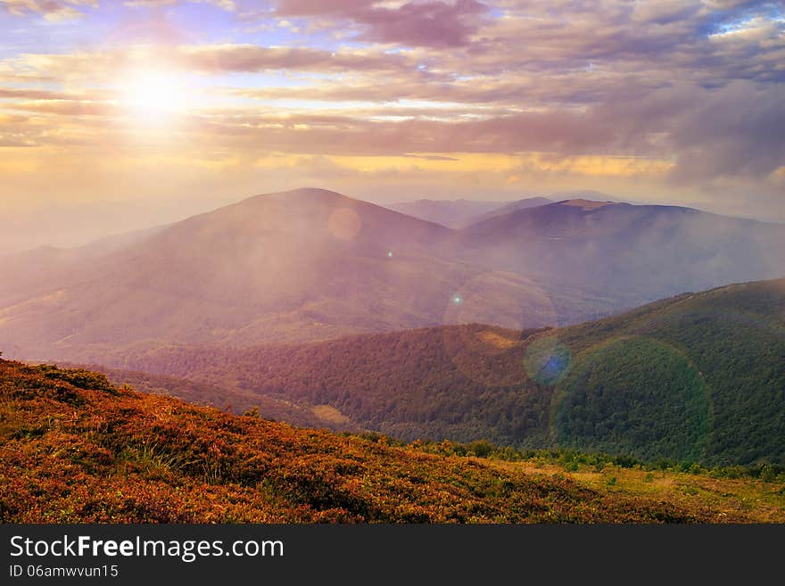 Mountain landscape. valley with stones on the hillside. forest on the mountain under the beam of light falls on a clearing at the top of the hill. in morning light. Mountain landscape. valley with stones on the hillside. forest on the mountain under the beam of light falls on a clearing at the top of the hill. in morning light