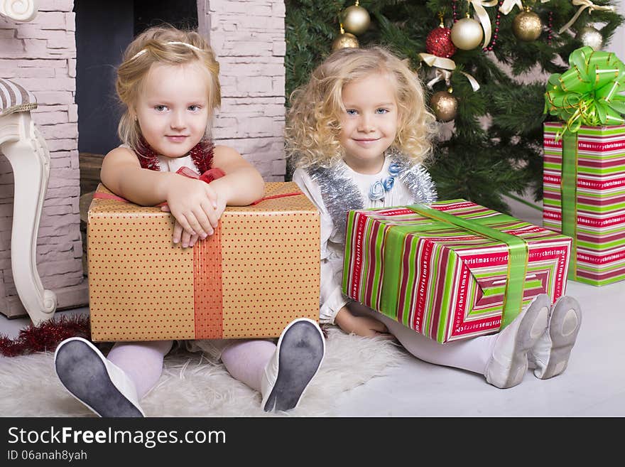 Funny little girls with Christmas gifts. Funny little girls with Christmas gifts