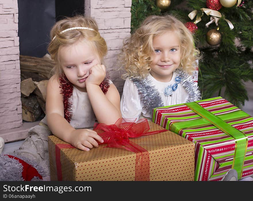 Funny little girls with Christmas gifts. Funny little girls with Christmas gifts