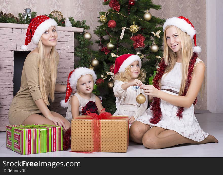 Happy family in Santa's hat with gifts. Happy family in Santa's hat with gifts