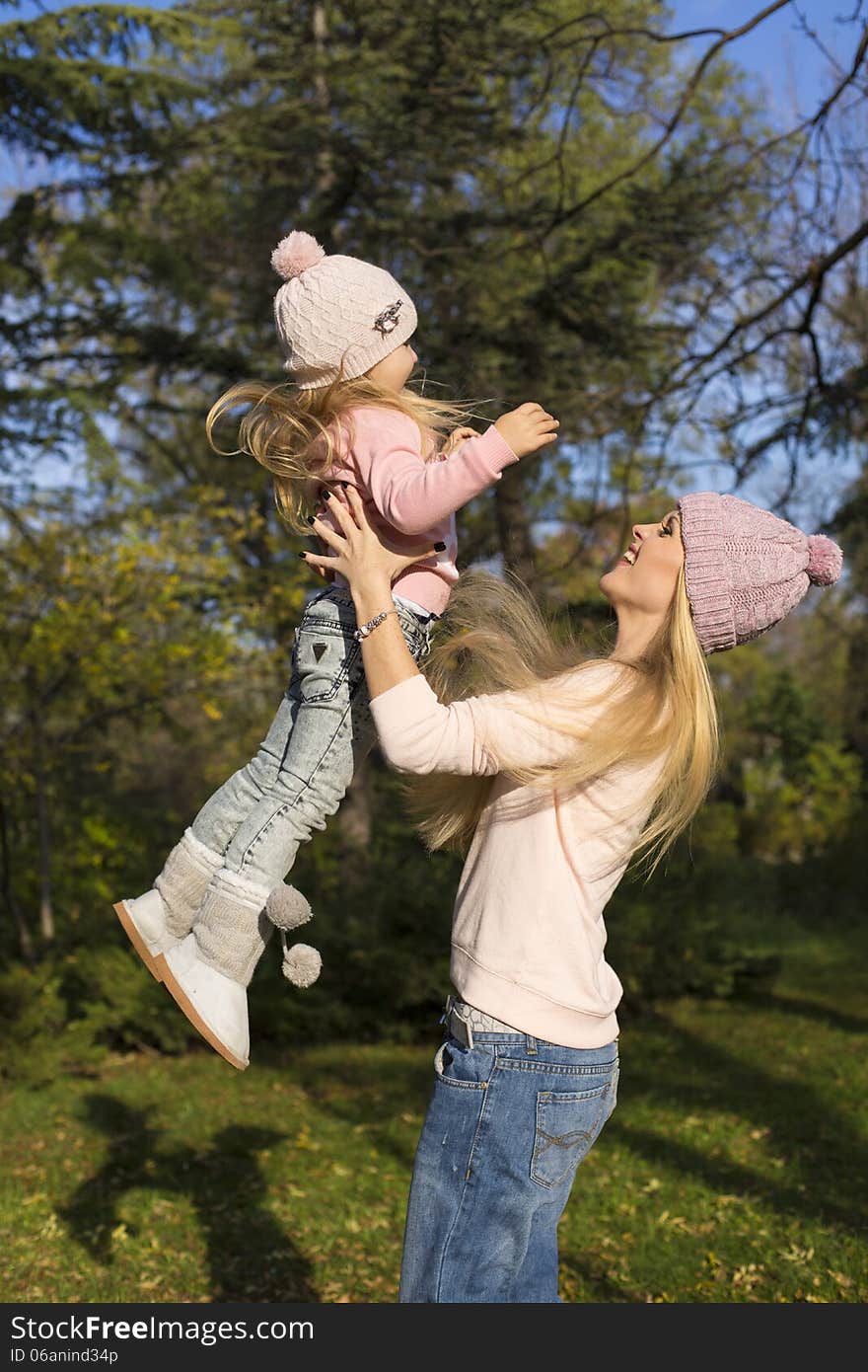 Mother and her little girl having fun in park