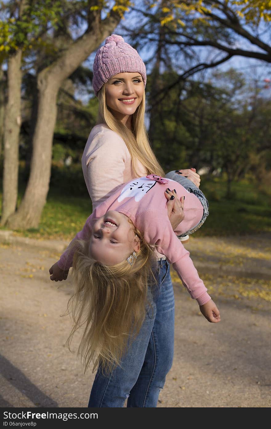 Mother and her little girl having fun in park