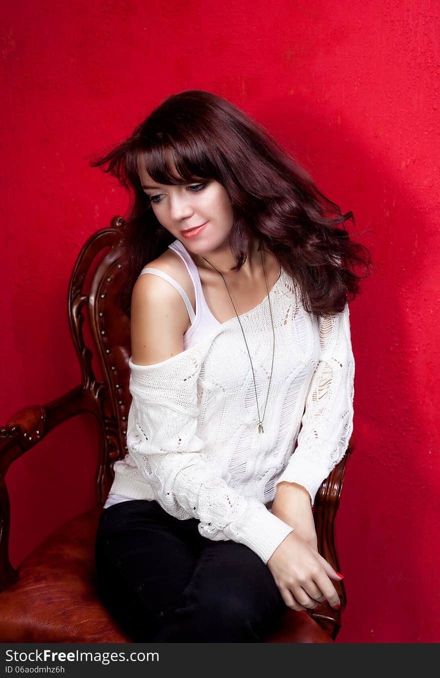 Beauty Portrait Of Woman On Vintage Chair On Red Backround