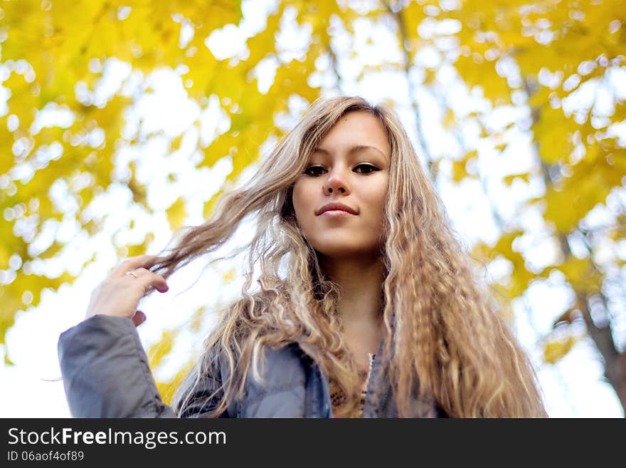 Gorgeous Young Woman On Yellow Autumn Leaves Background