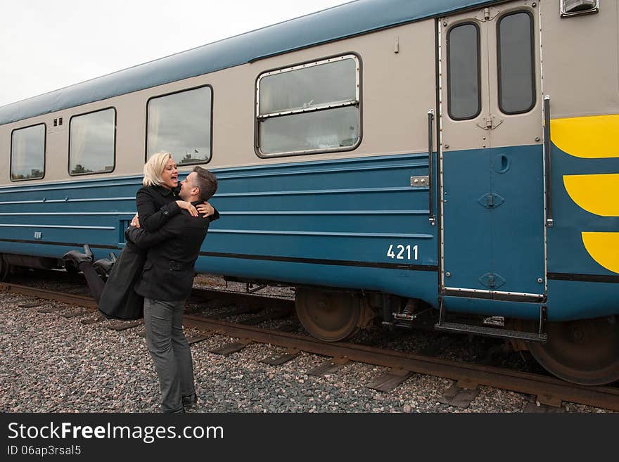 Big hug beside train carriage