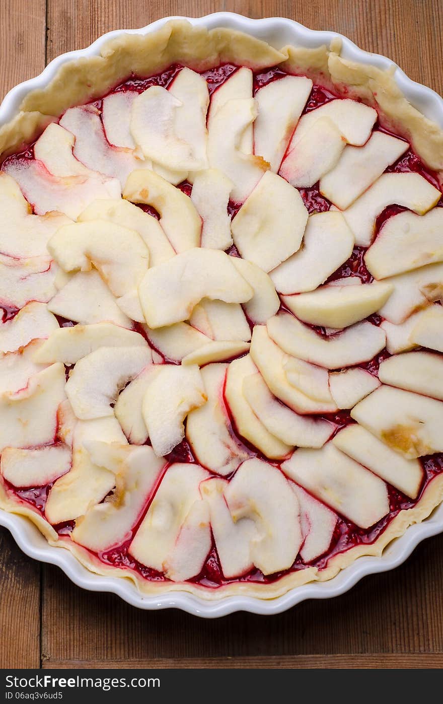 Apples and raspberries tart ready to be baked. Apples and raspberries tart ready to be baked