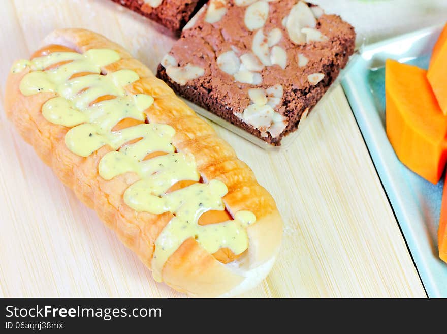 Closeup hot dog with mustard relish sauce and chocolate bread. Closeup hot dog with mustard relish sauce and chocolate bread