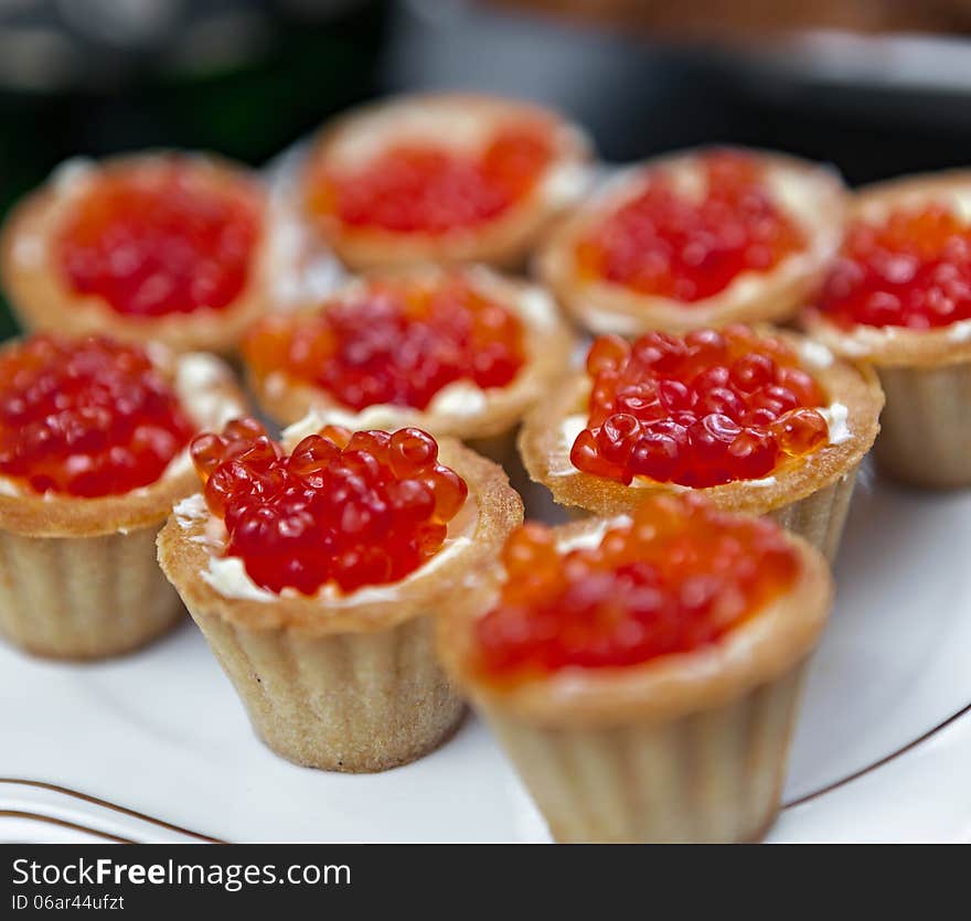 Red caviar in baskets of dough