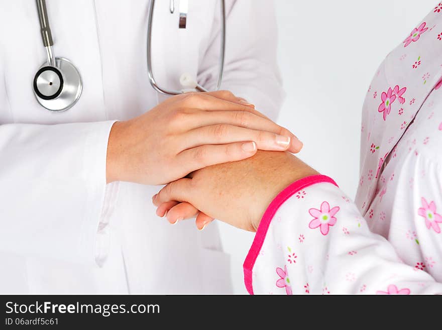 Holding patient hand in hospital