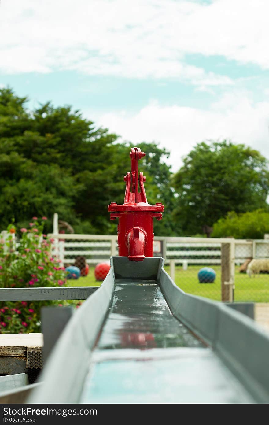 Red Retro Water Pump in farm