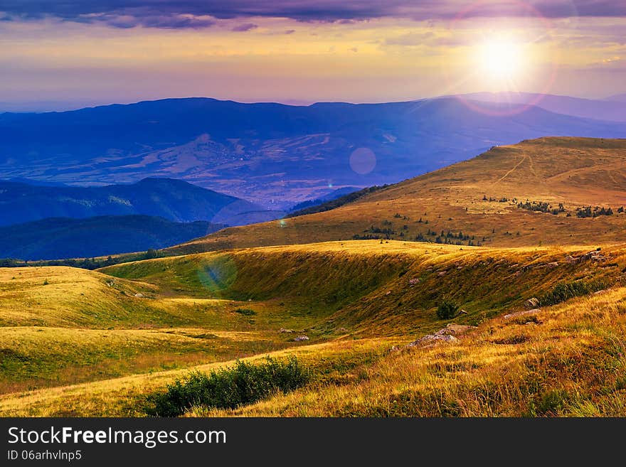 Mountain landscape. valley with stones on the hillside. forest on the mountain under the beam of light falls on a clearing at the top of the hill. Mountain landscape. valley with stones on the hillside. forest on the mountain under the beam of light falls on a clearing at the top of the hill.