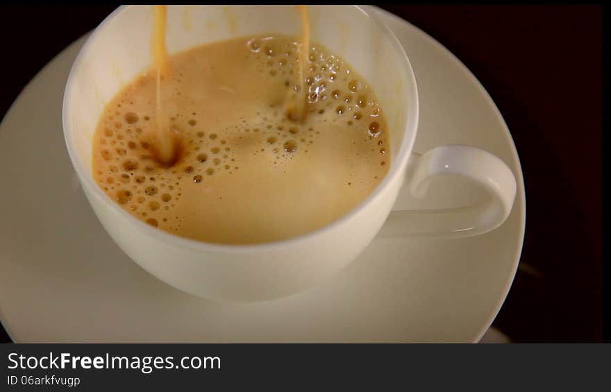 Coffee pouring into a cup. Coffee pouring into a cup