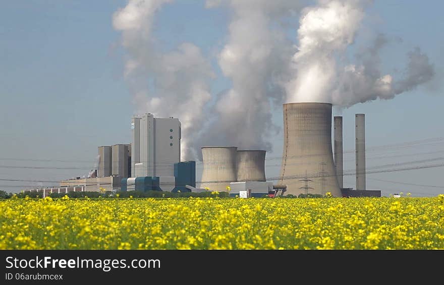 Windmills and a coal burning power plant. Windmills and a coal burning power plant