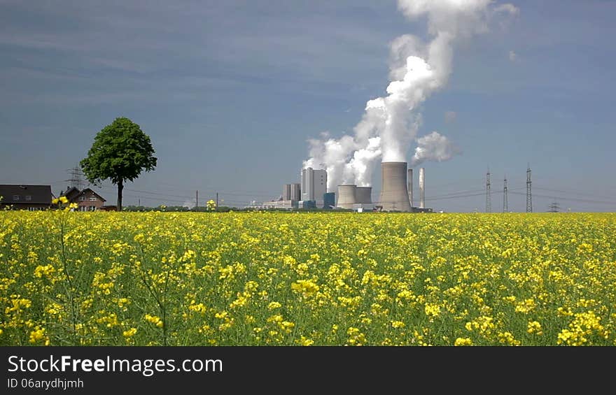 Windmills and a coal burning power plant. Windmills and a coal burning power plant