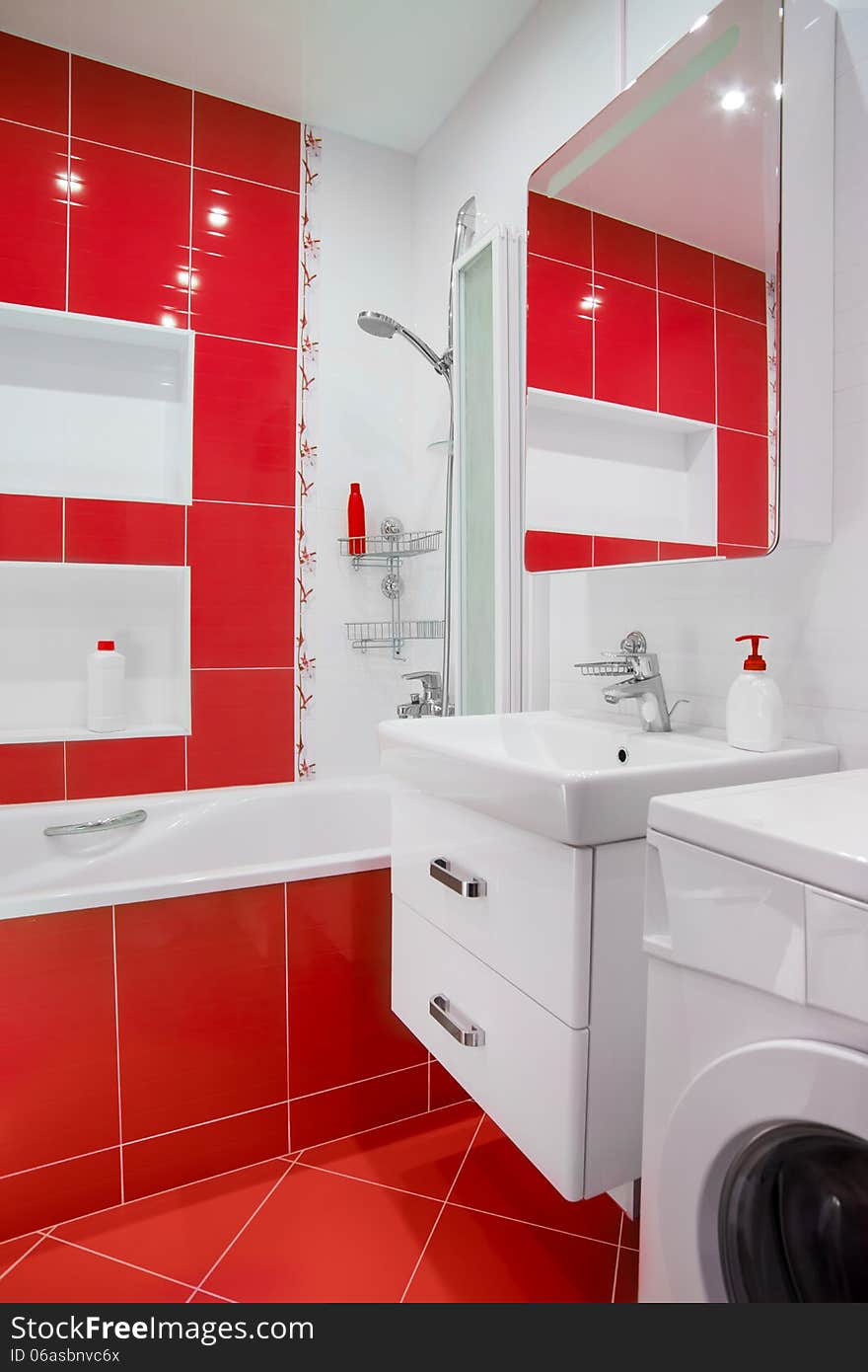 Modern red bathroom interior with tube and washing machine. Modern red bathroom interior with tube and washing machine