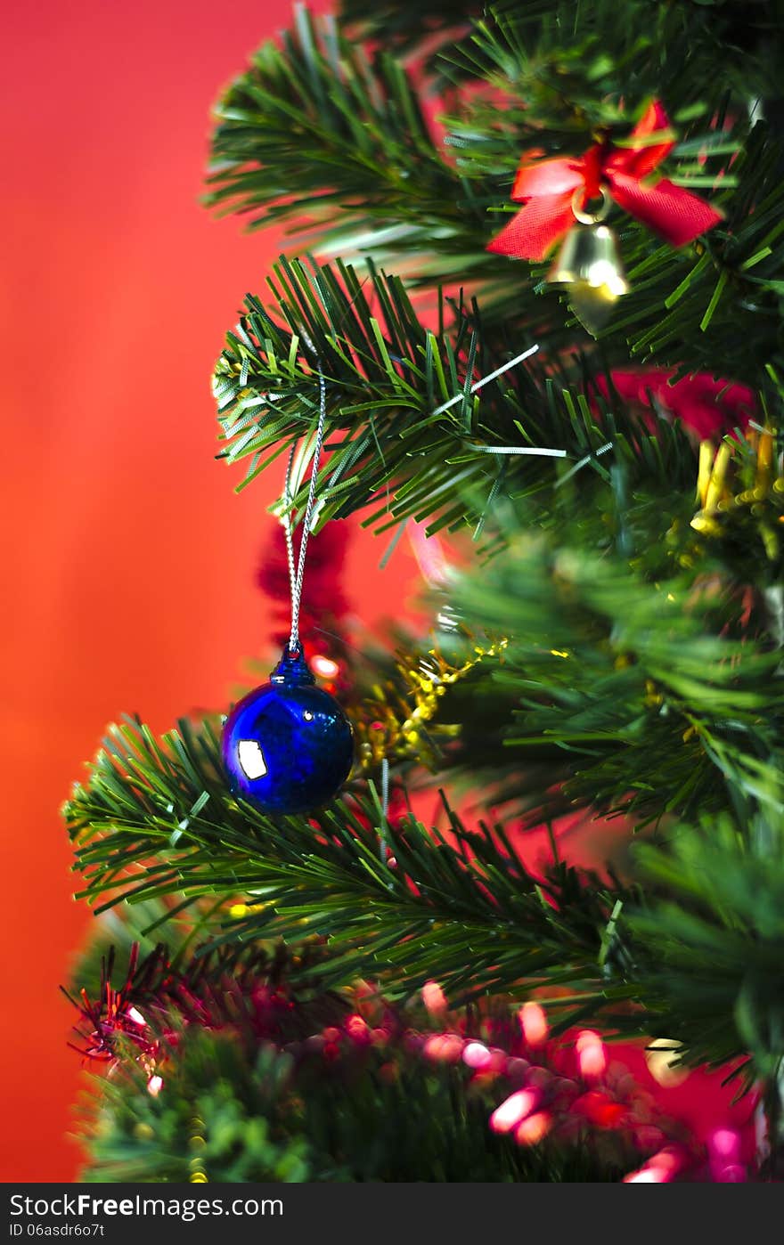 Blue christmas ball on tree on red background