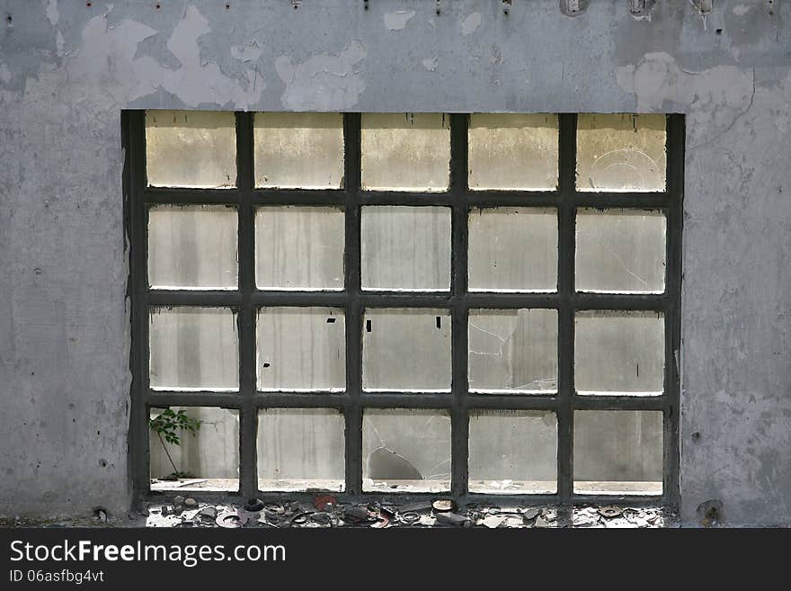 Broken old window in the ruined house