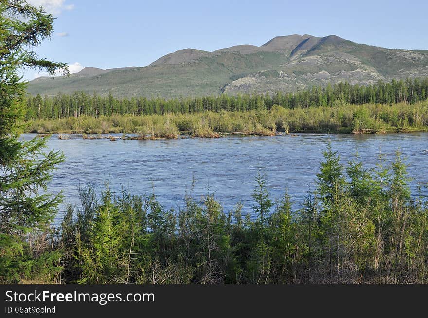 Water summer landscape surrounding the river Suntar in the Highlands of Oymyakon, Yakutia, Russia. Water summer landscape surrounding the river Suntar in the Highlands of Oymyakon, Yakutia, Russia.