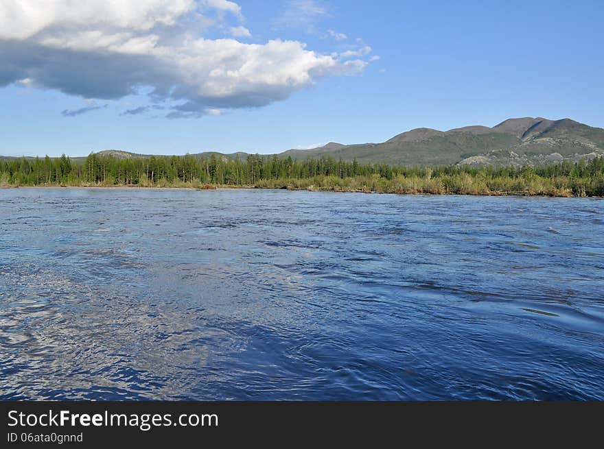 Water summer landscape surrounding the river Suntar in the Highlands of Oymyakon, Yakutia, Russia. Water summer landscape surrounding the river Suntar in the Highlands of Oymyakon, Yakutia, Russia.