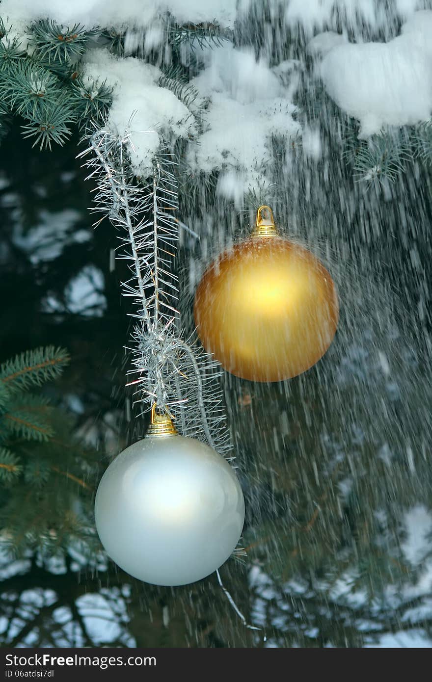 Christmas balls on a fir-tree in snow