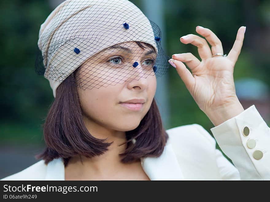 Beautiful girl in a hat with a veil. Beautiful girl in a hat with a veil