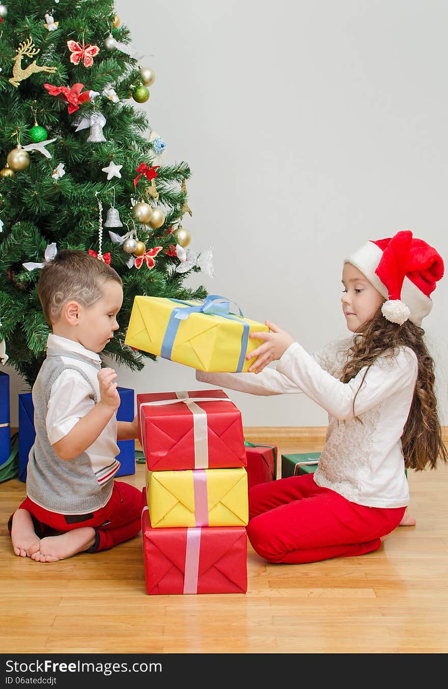 Brother and sister packing christmas gifts