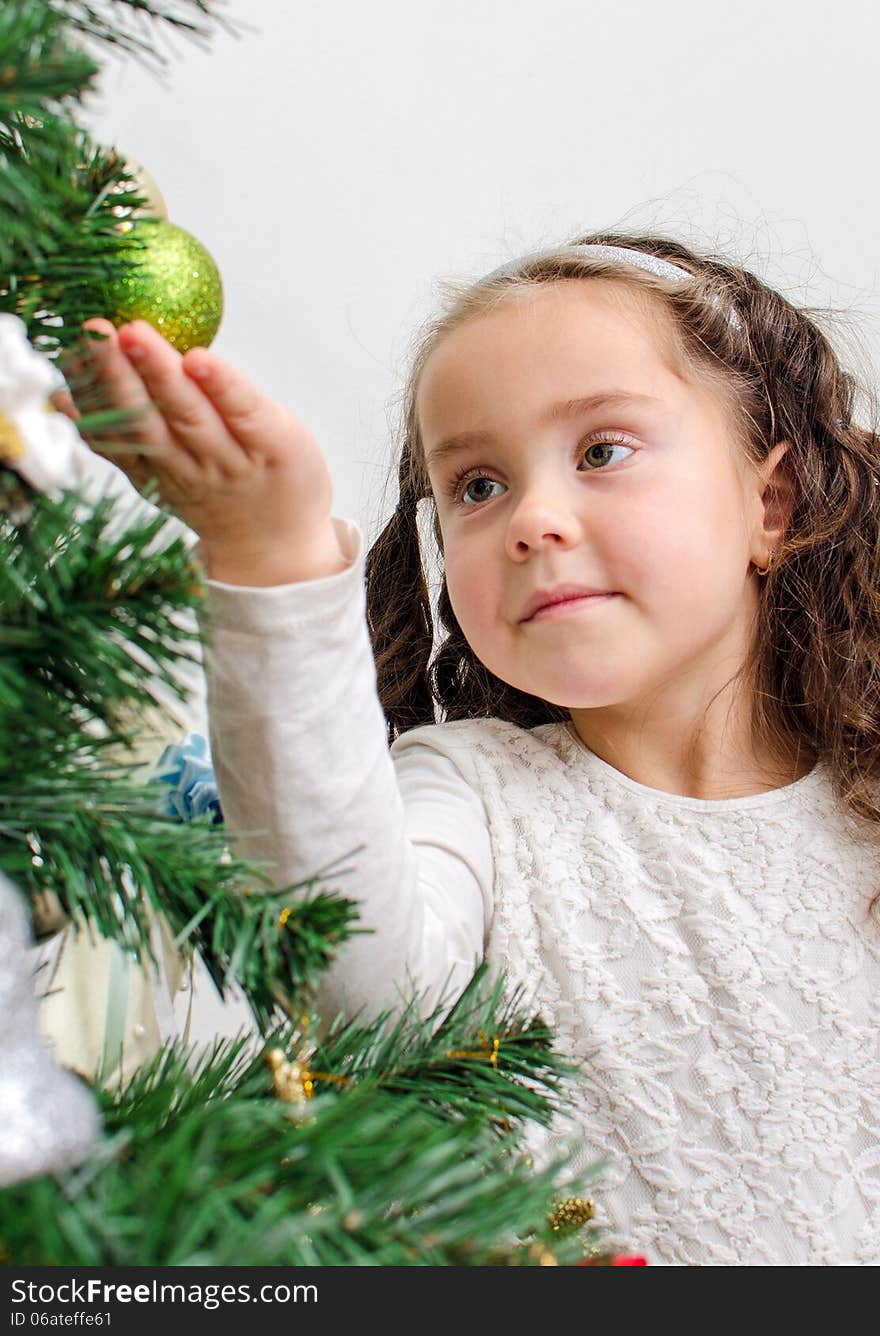 Little girl decorates tree