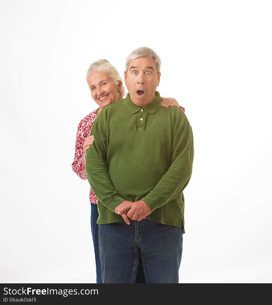 An elderly couple isolated on a white background with happy and surprised expressions. An elderly couple isolated on a white background with happy and surprised expressions