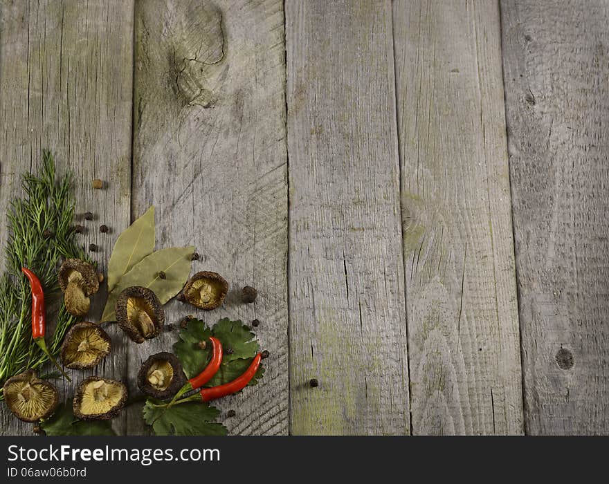 Dry mushrooms border horizontal on wood