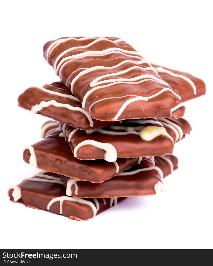 Stack of Chocolate Biscuits with Striped Milk Chocolate Glazed isolated on white background