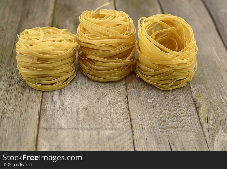 Group of rolled noodles on the wooden table. Group of rolled noodles on the wooden table