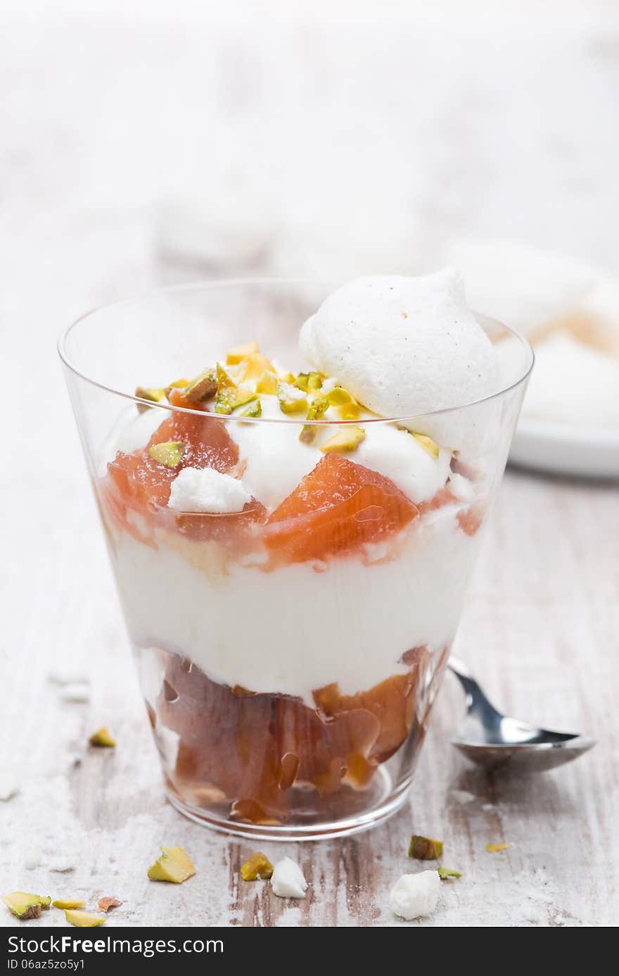 Dessert with canned peaches, whipped cream and meringue, closeup