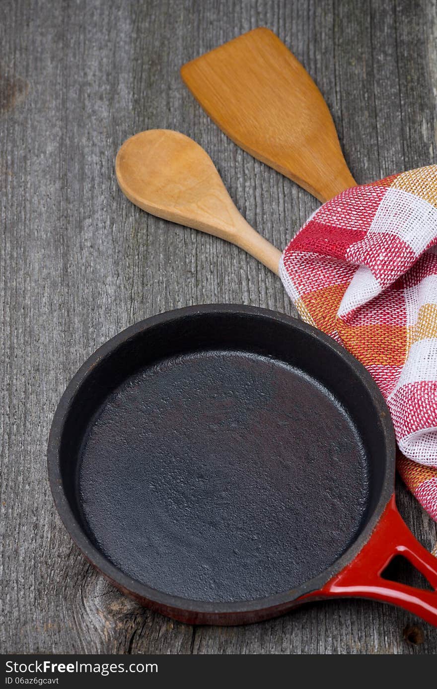 Empty frying pan, wooden spoon and spatula, concept