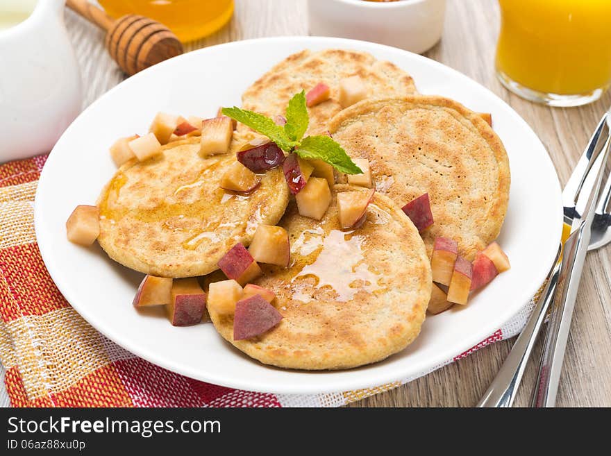 Homemade pancakes with peaches and honey, top view