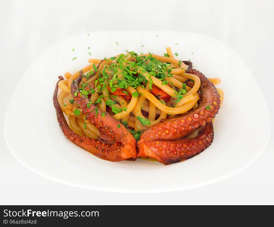 Typical dish of Italian and mediterranean cuisine, made from fresh pasta, cherry tomatoes, octopus, olive oil and parsley. Typical dish of Italian and mediterranean cuisine, made from fresh pasta, cherry tomatoes, octopus, olive oil and parsley.