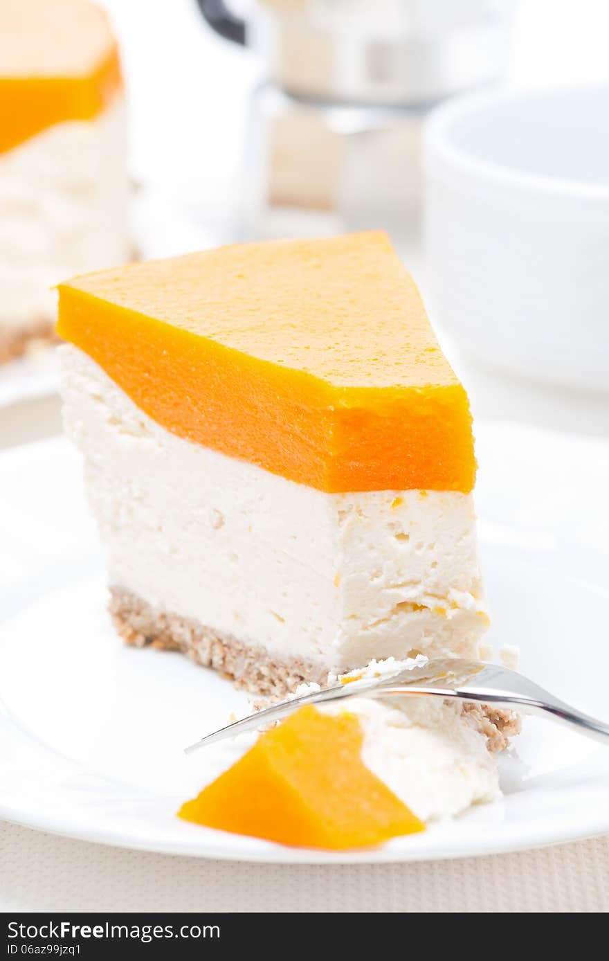 Piece of cheesecake with pumpkin jelly, vertical, close-up