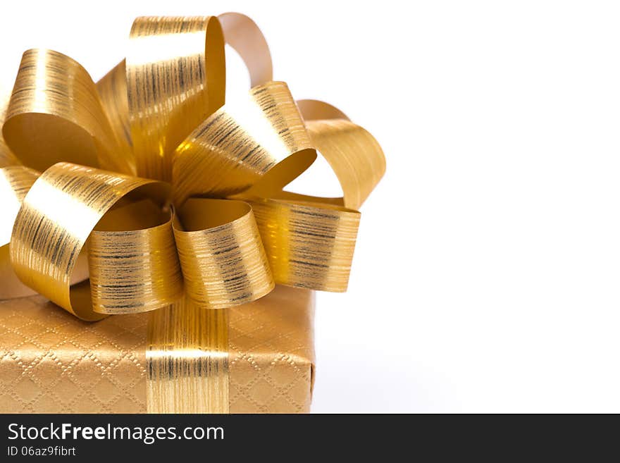 Part of the golden gift box, close-up, isolated on white. Part of the golden gift box, close-up, isolated on white