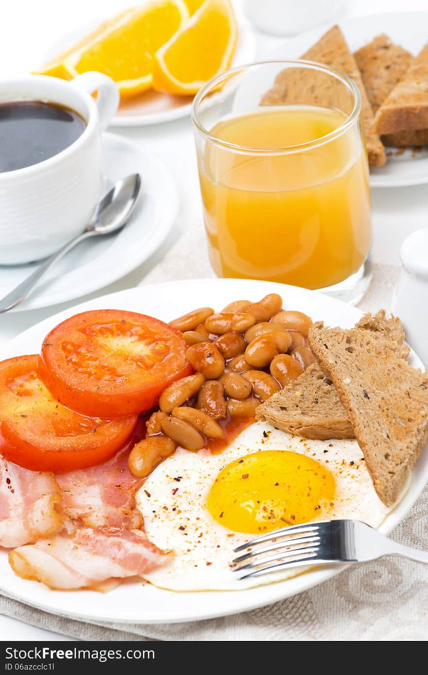 Traditional English breakfast with eggs, bacon, beans, coffee