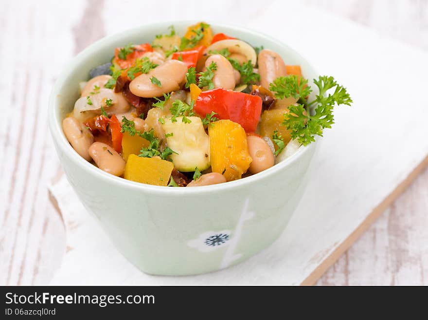 Vegetable stew with beans in a bowl, close-up