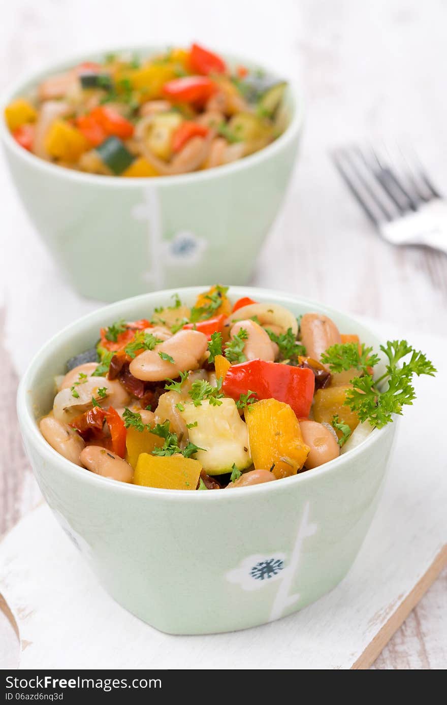 Vegetable stew with beans in the bowls, vertical