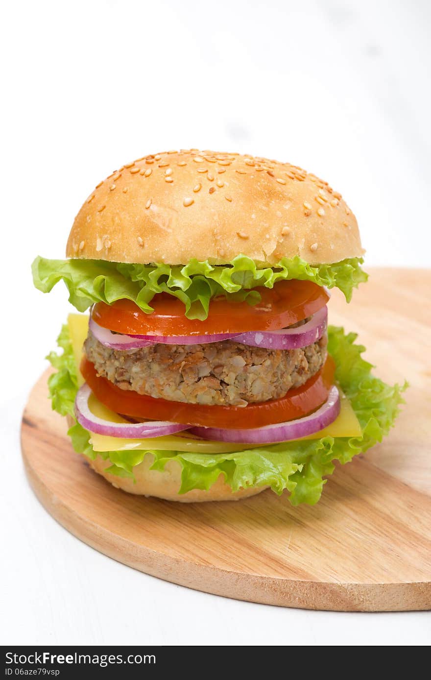 Burger with a vegetarian cutlet and fresh vegetables, close-up